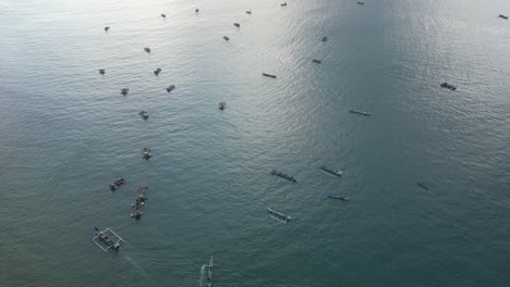 Looking-down-at-dozens-of-boats-on-the-coastline-of-Lombok,-Indonesia