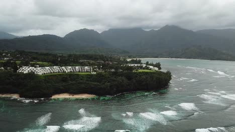 Waves-breaking-towards-the-coastline-of-a-Polynesian-Island-in-the-Pacific-Ocean,-Aerial-View