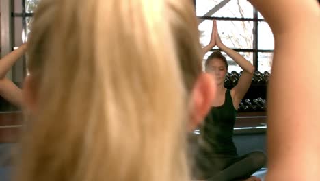 fit group doing yoga in the gym