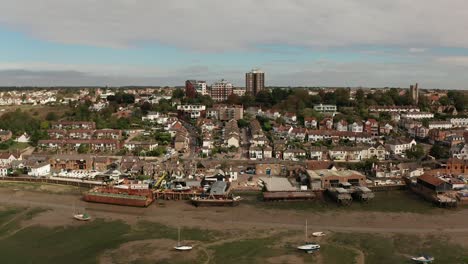 Slow-sweeping-shot-from-right-to-left-of-coastal-fishing-village-over-marshes