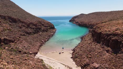 desert island bay, boat and people moored on deserted empty beach, espiritu santo, baja california sur, mexico