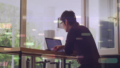 working on laptop, man analyzing data with processing animation overlay