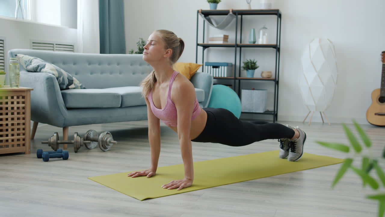 Woman doing a Downward-Facing Dog yoga pose at home