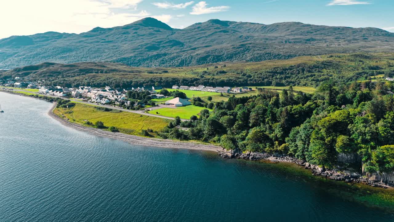 Aerial View of a Village by a Lake with Mountains