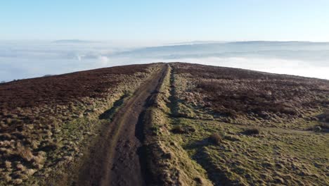 cloudy misty sunrise valley aerial moorland hiking hillside following muddy path lancashire