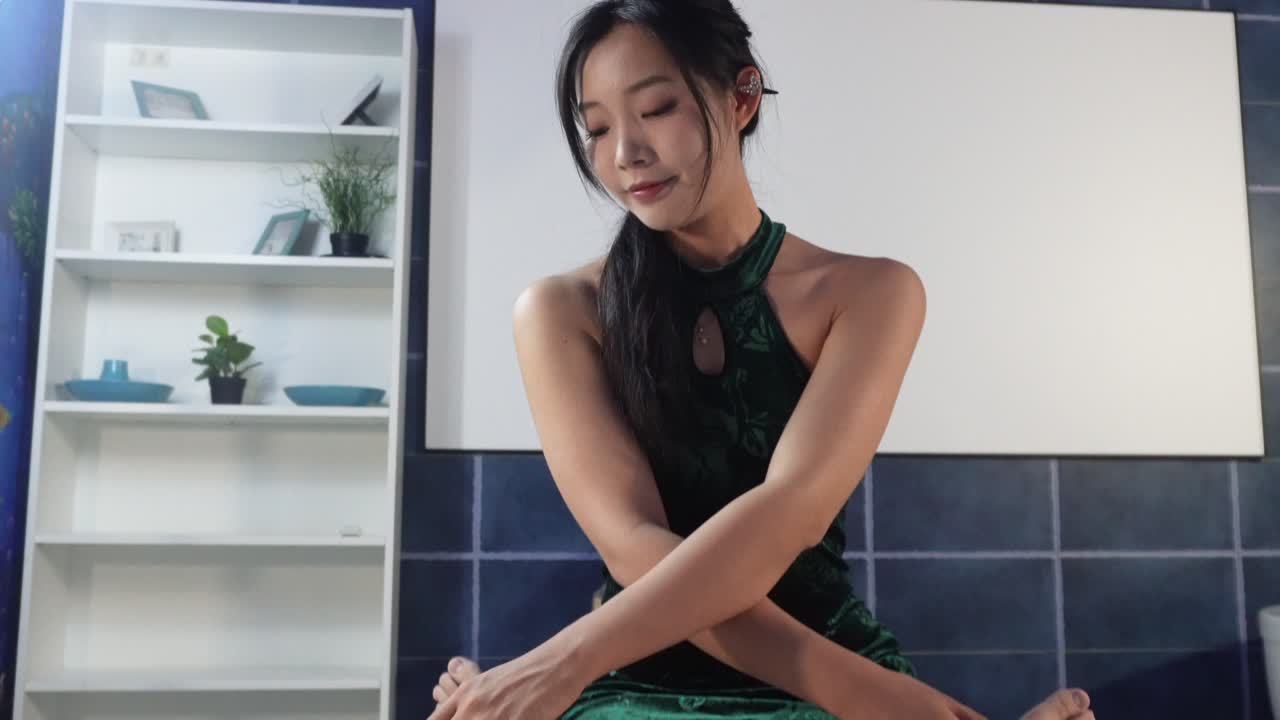 Beautiful female masseuse is concentrating on giving relaxing massage to the client.