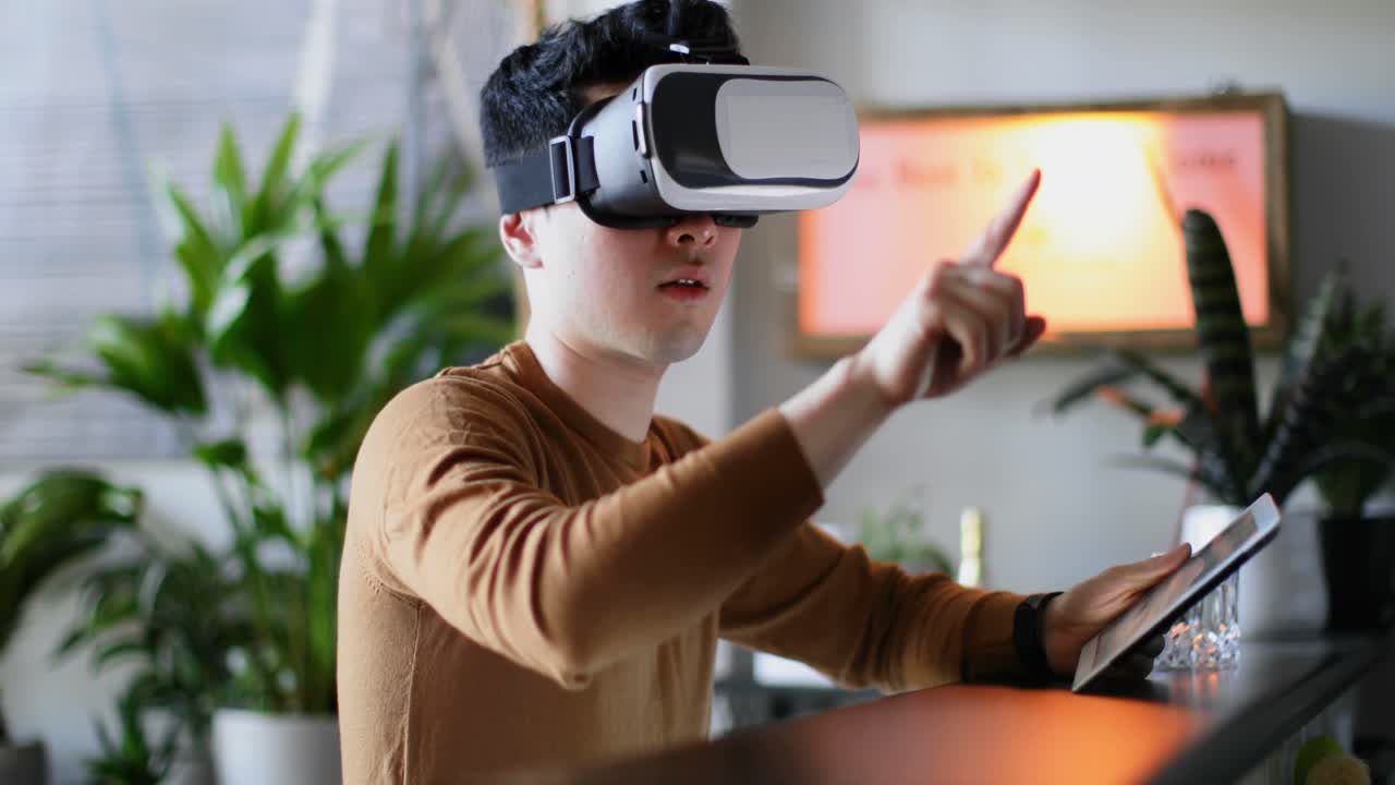 Uomo che usa un tablet e un visore VR sul piano della cucina 4k