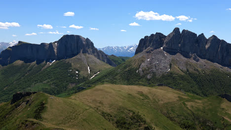 zoom out landscape view of the rocky caucasus mountains valleys and forests, on a sunny day