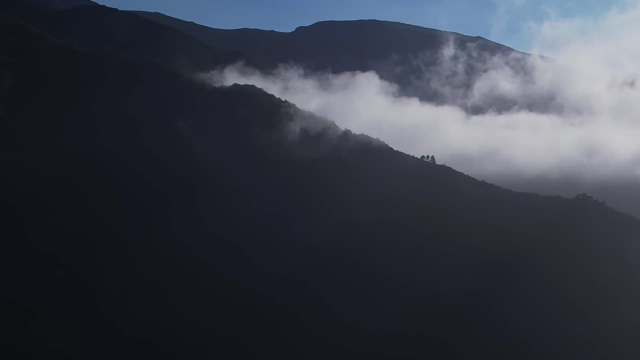 Stunning aerial view of mountains shrouded in clouds over Madeira, Portugal