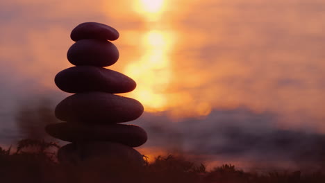 Tower-Of-Stones-Against-The-Background-Of-The-Sea-At-Sunset