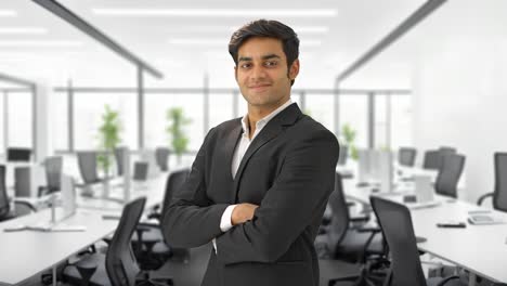 Successful-Indian-businessman-standing-crossed-hands