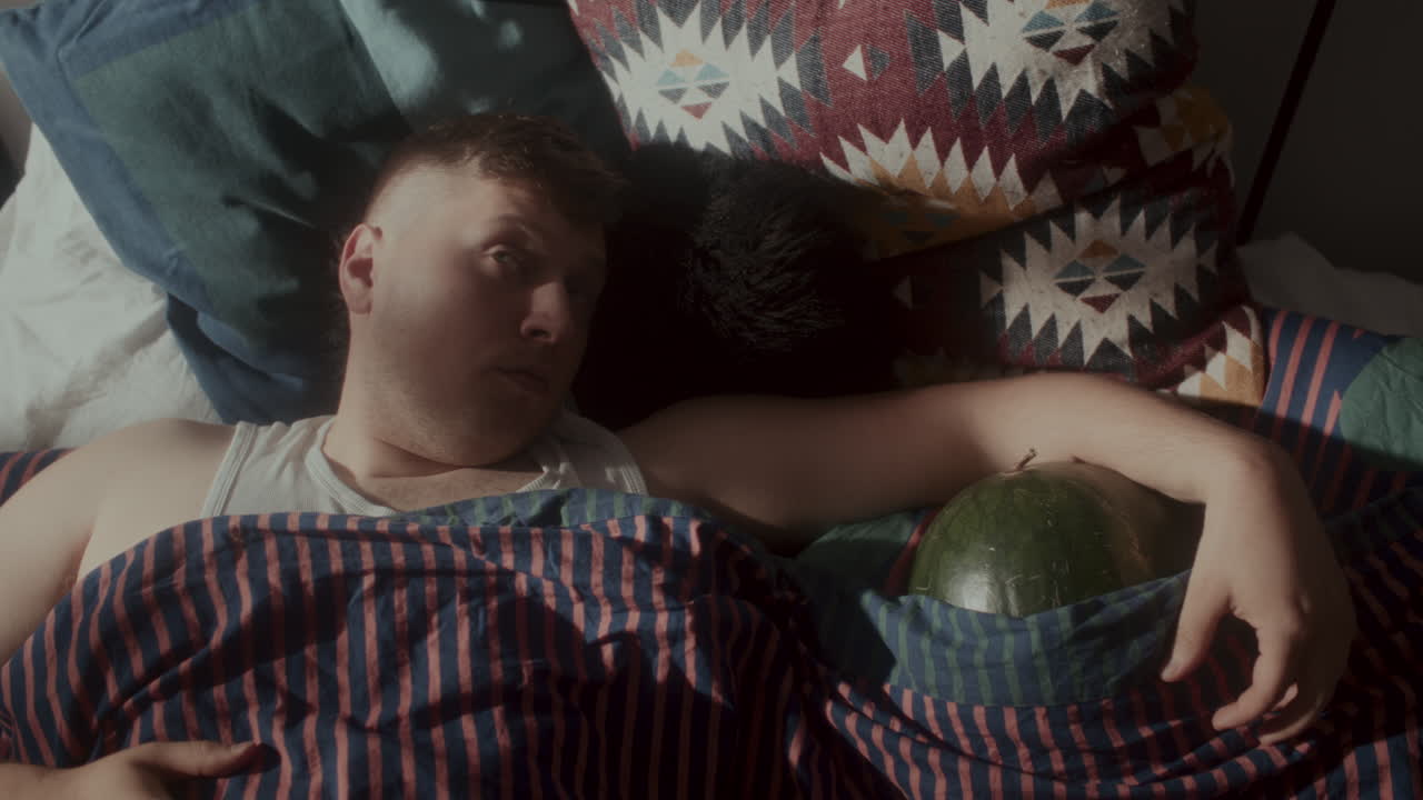 Man Sleeping in Bed with Watermelon