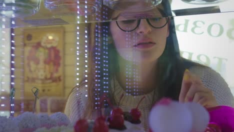 woman choosing dessert in a bakery