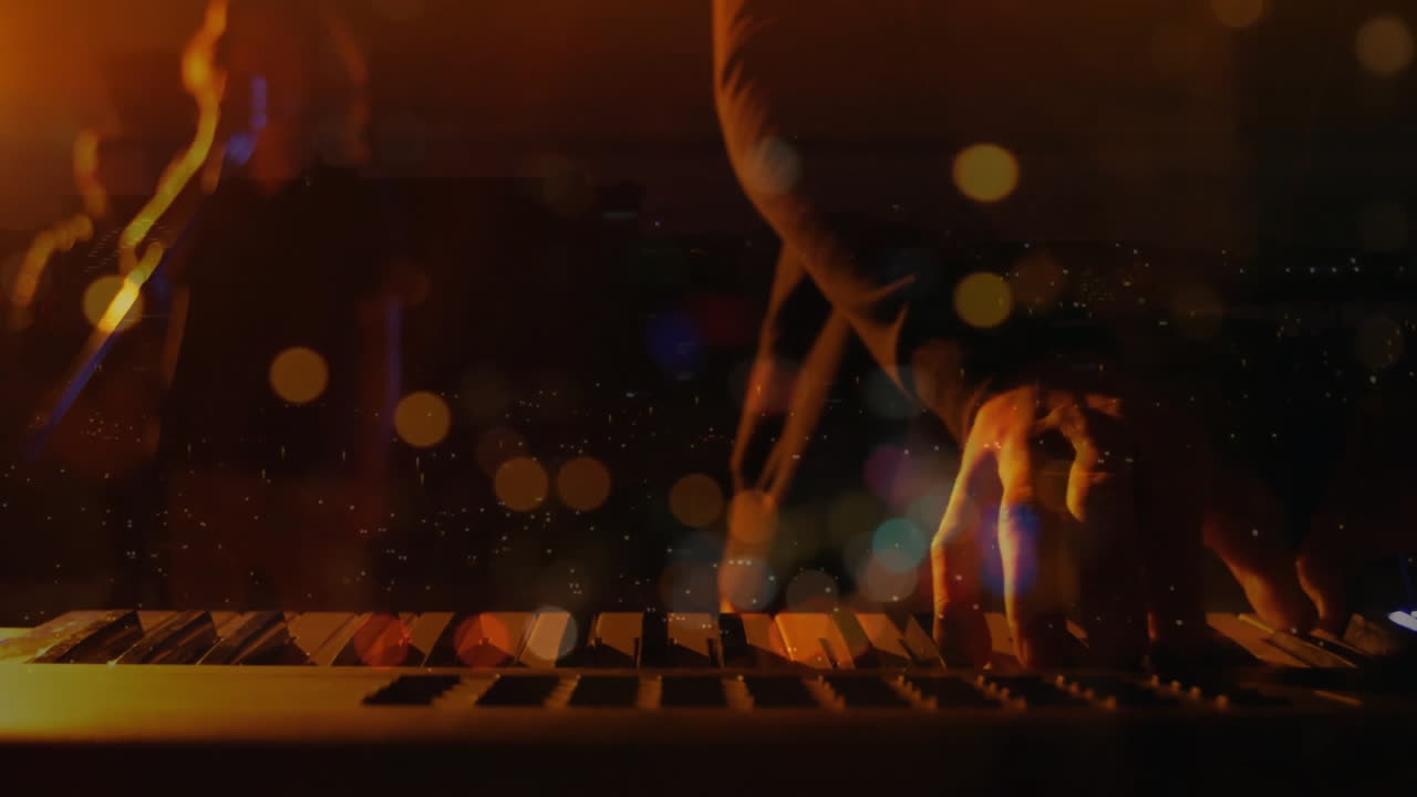 손과 키 위에 다채로운 보케 애니메이션으로 키보드를 연주합니다.