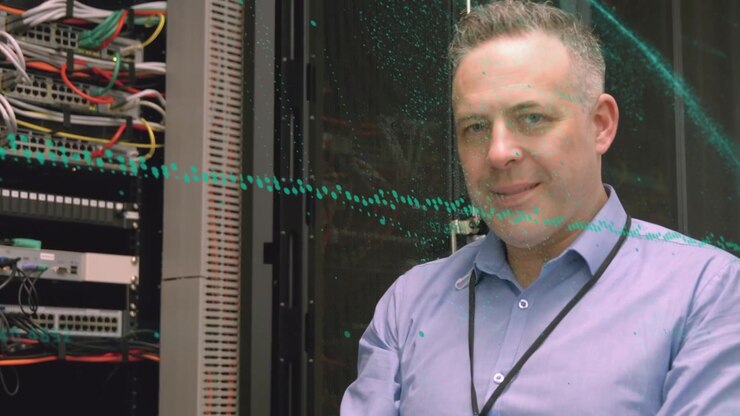 Animation of spots over caucasian businessman in server room