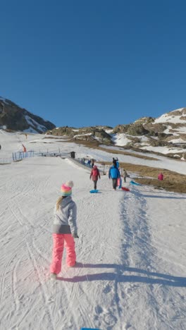 children sledding in the mountains