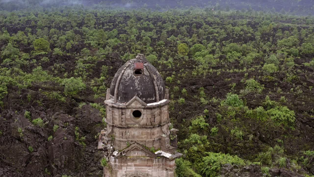 Camera rises smoothly revealing the ruined church with lush forest in the background