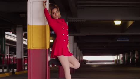 a young hispanic maiden, clad in a short red dress, roams the city's parking garage