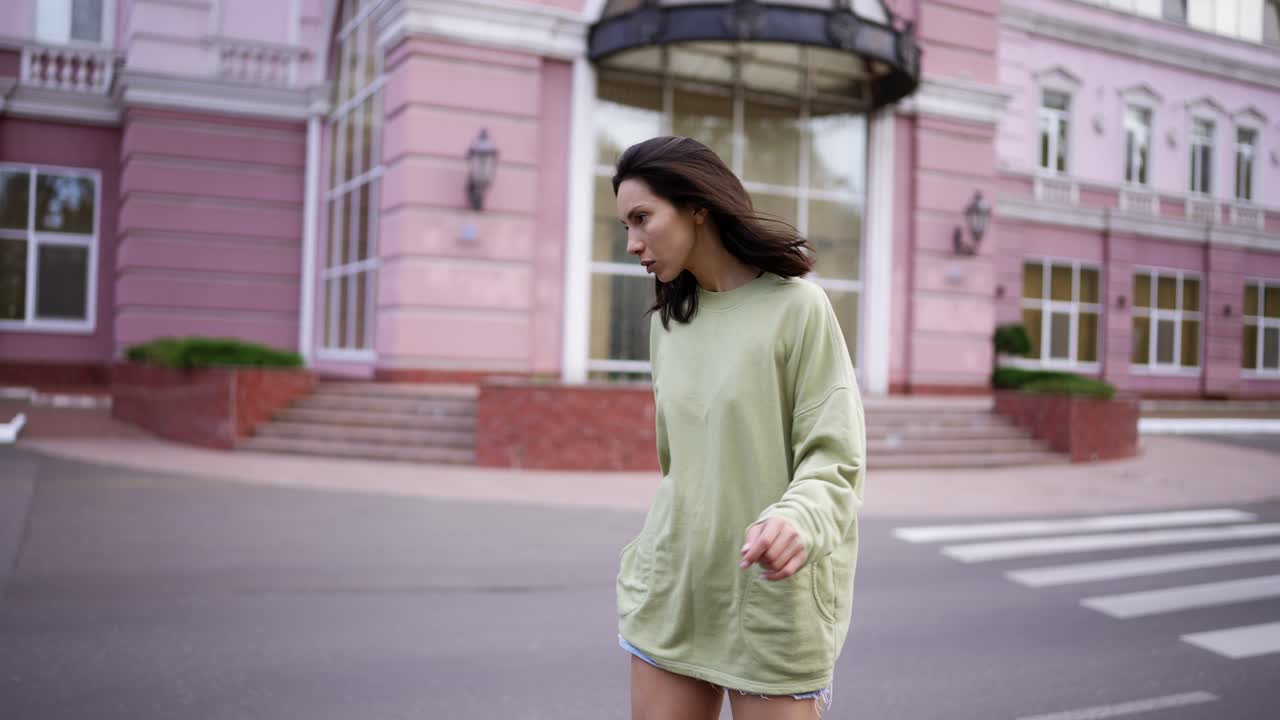 A young brunette girl runs up and rides a skateboard skillfully keeping her balance. Hobby, leisure