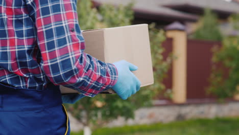 a courier with a parcel walks along the street 1