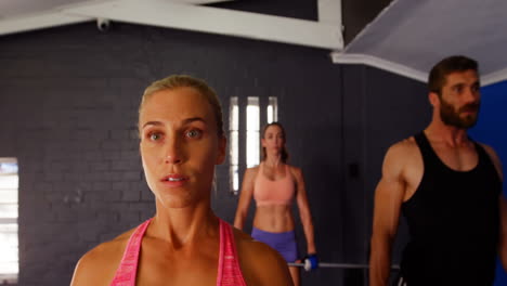 group of people lifting barbell