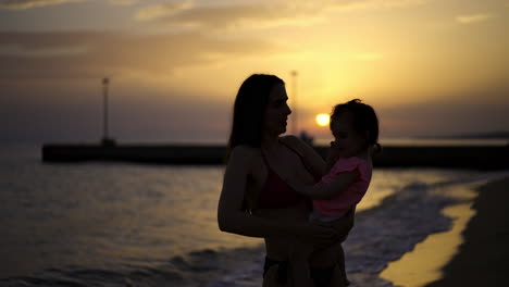 mother and child at sunset on the beach