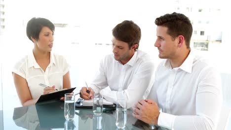 cheerful colleagues speaking during a meeting