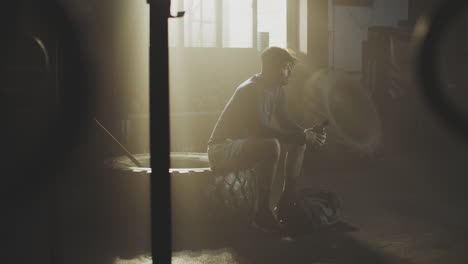 man resting in a gym