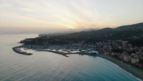 Aerial-overview-of-breathtaking-seaside-village-comune-and-Varazze-marina-shipyard-with-incredible-cloudscape-and-turquoise-ocean-bay
