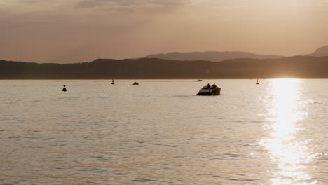 sunset on a lake with boats