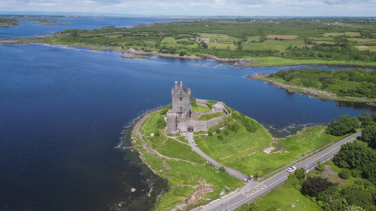 aerial drone view overflying the beautiful Dunguaire Castle in Kinvarra. A 16th century medieval castle built in the shore of Galway bay - Famous touristic attraction in Ireland. Co Galway