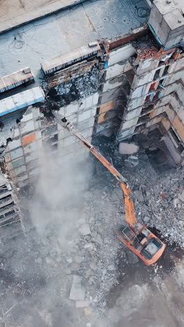 urban regeneration. demolition of a building for new construction. dismantling of a house. aerial view. vertical video