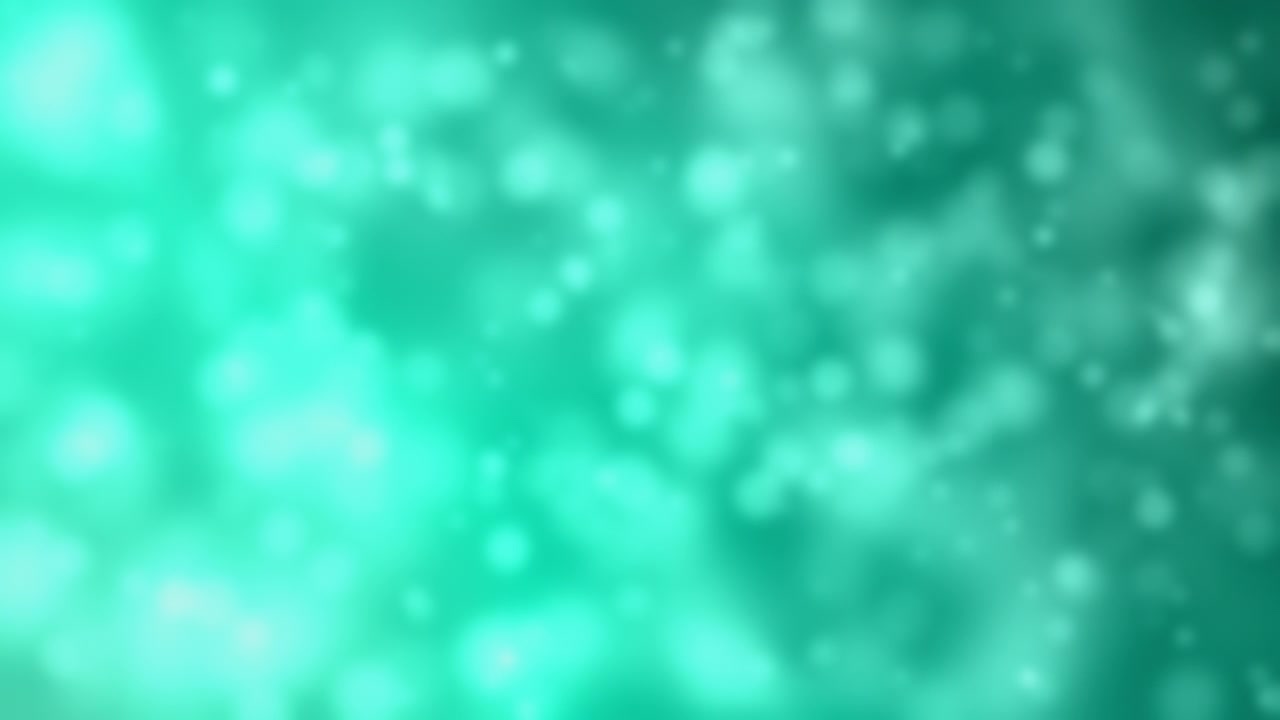 Soft teal bokeh lights create a dreamy and festive abstract background, perfect for celebratory themes.