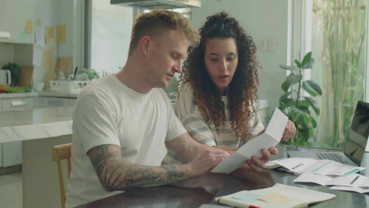 Married Couple Discussing Bills and Managing Money at Home