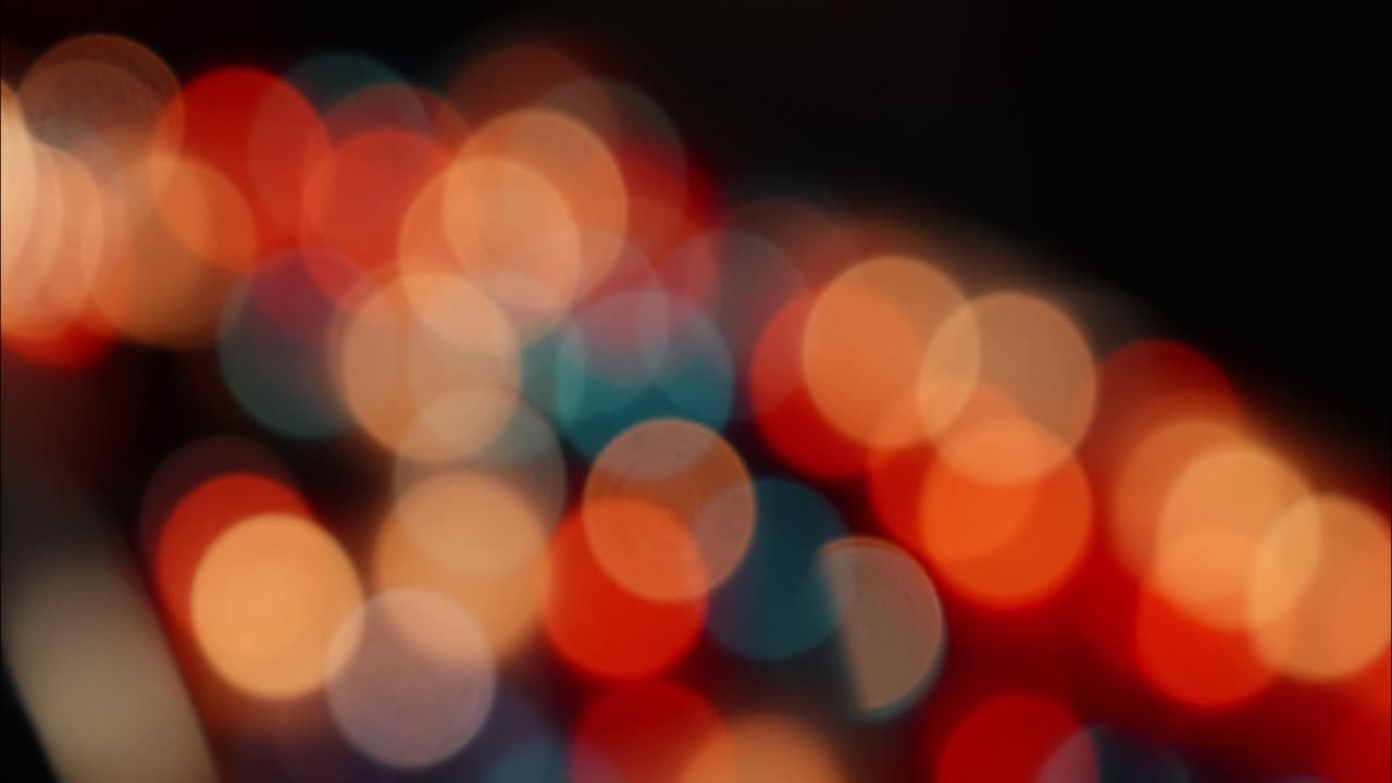 Colorful Bokeh Lights Shifting on a Dark Abstract Background