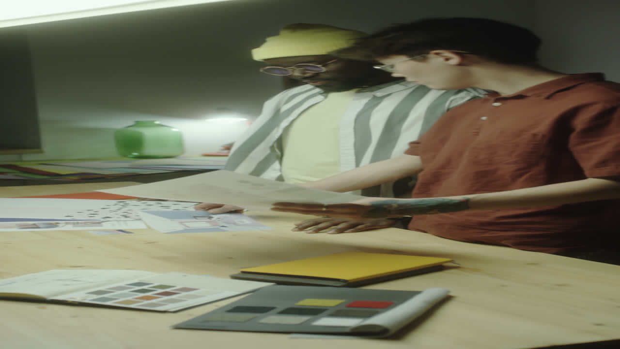 Two Men Collaborating on a Design Project at a Desk