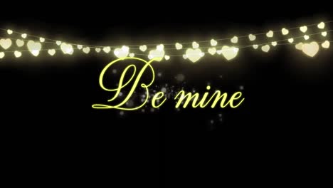 Animation-of-Be-Mine-written-in-golden-letters-on-black-background-with-a-hearts-garland