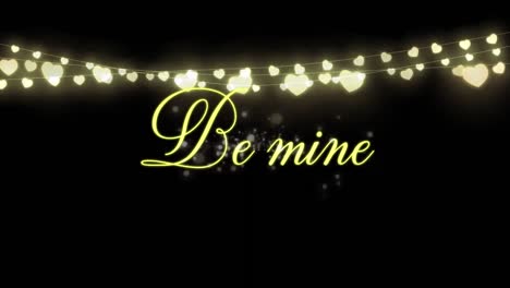 animation of be mine written in golden letters on black background with a hearts garland