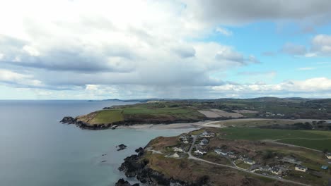 little cove, warren sandy beach near rosscarbery in ireland with dramatic skies and calm blue ocean, an aerial footage