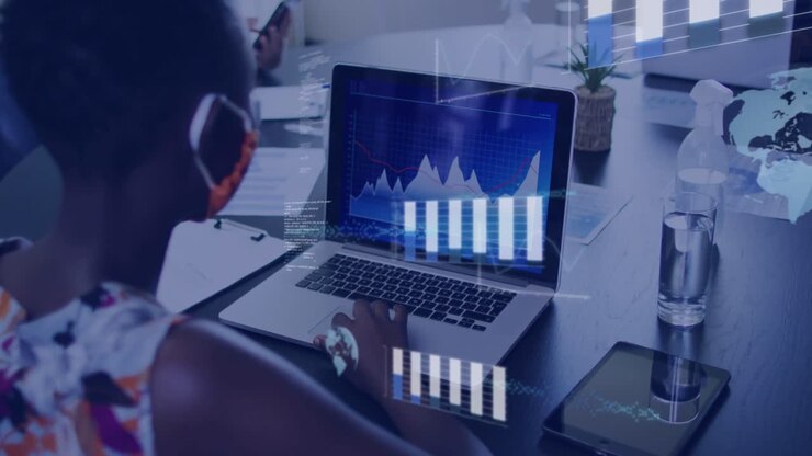 Kvinne bruker laptop, berører styreflaten og aktiverer finansdiagrammer som forvandles til stablede søyler for demonstrasjon