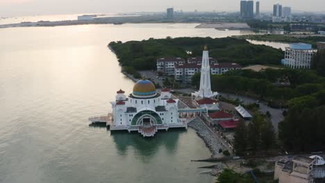 aerial drone establishing b-roll footage of melaka straits floating mosque during sunset