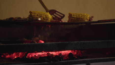 roasting meat and corn on charcoal grill