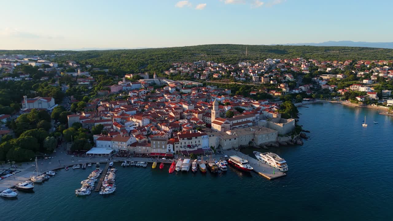 Aerial View of Krk, the Capital City of the Croatian Island of Krk, Adriatic Coast, With Harbor and Red Tiled Roofs. Blue Sea,with Sailboats, Sandy Beaches and the Historic Old Town at Sunset Croatia