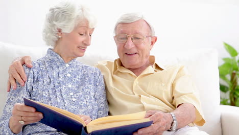 old couple looking through photo album