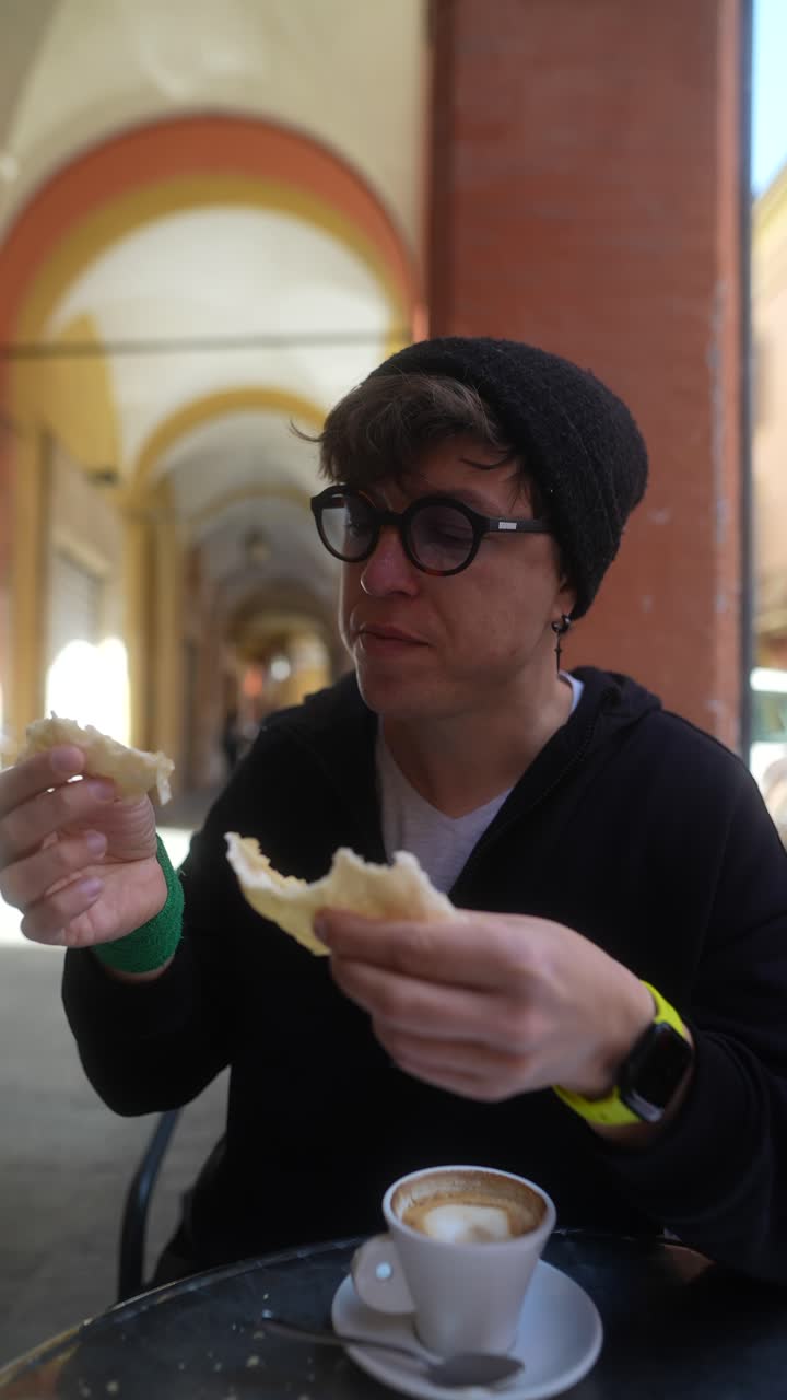 Person enjoying a coffee break and bread in an outdoor cafe