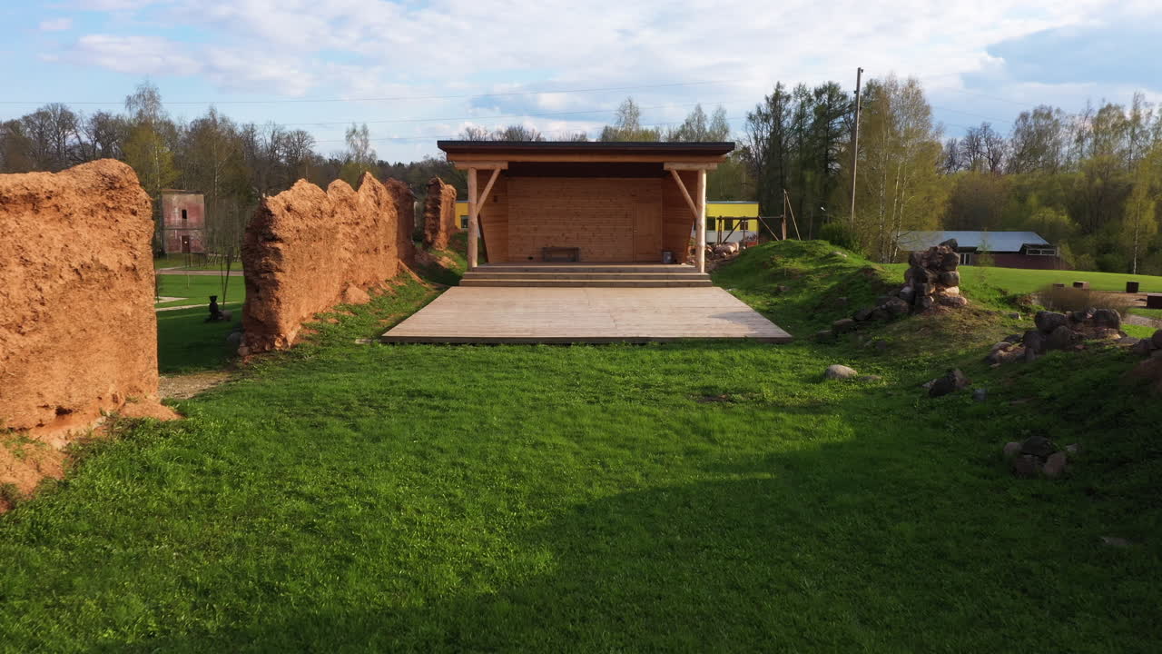 Outdoor Stage with Ancient Wall Ruins in Park Setting, dolly in