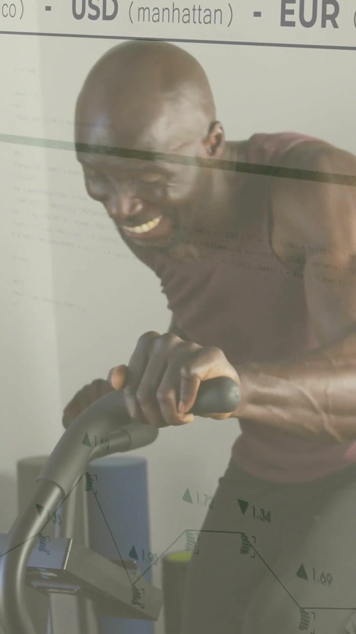 Vertical video: Mature man using console tracking stats pedaling bike USD EUR YEN overlaying on him