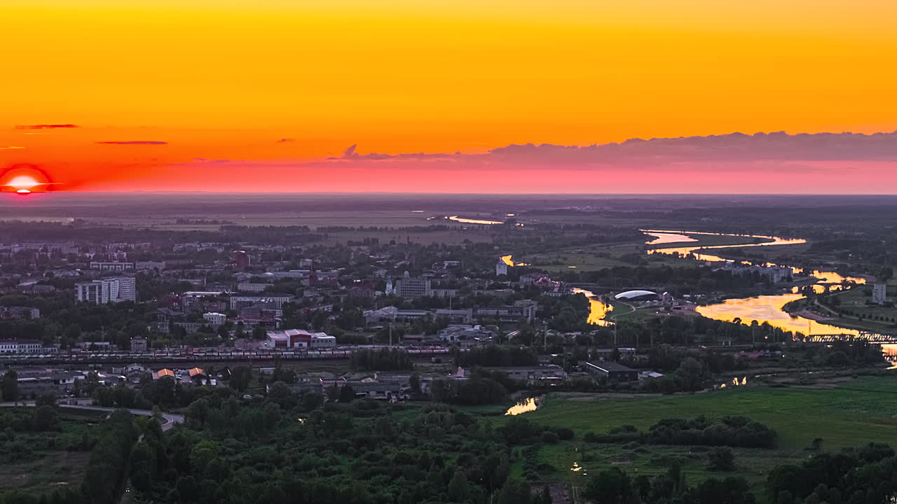 Aerial sunset hyperlapse over Jelgava city and Lielupe River in Latvia
