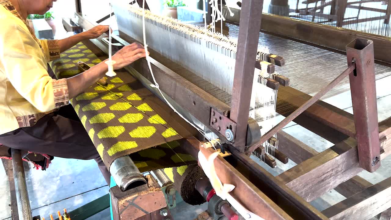 Artisan weaving silk fabric on a loom