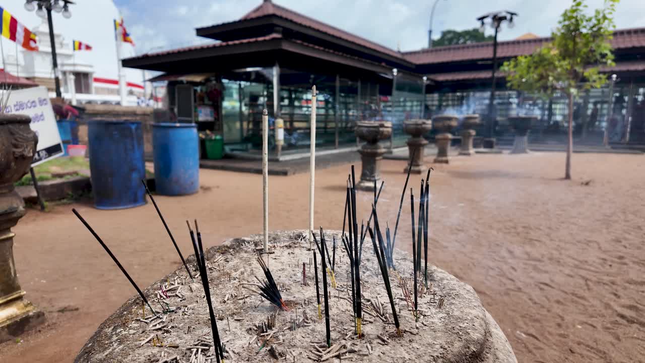 Incense sticks burning at The Ruwanweli Maha Seya, a sacred stupa located in Anuradhapura, Sri Lanka. The atmosphere evokes spirituality and tradition